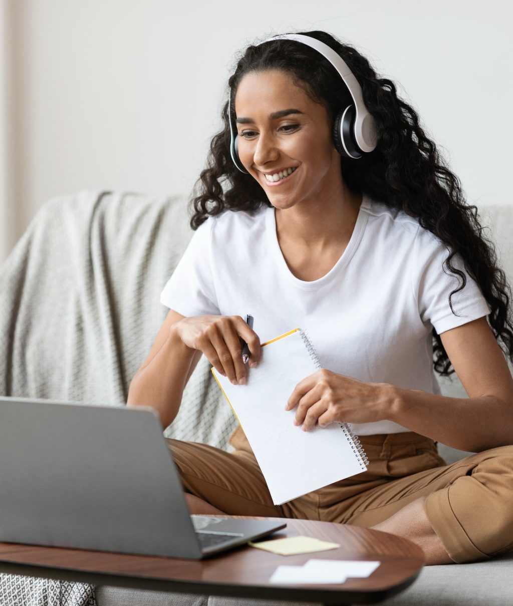 cheerful-lady-attending-online-course-using-laptop-and-wireless-headset.jpg